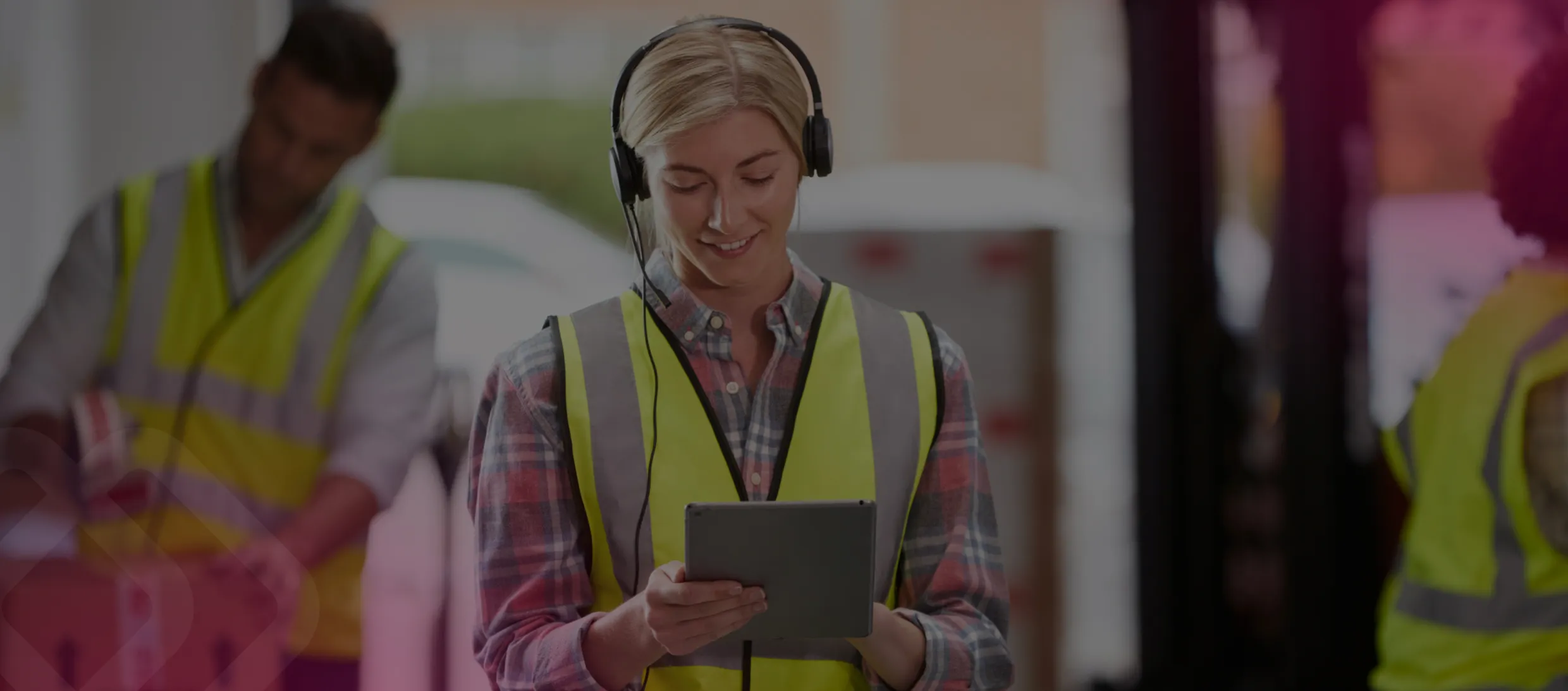 Colleagues in hi-vis using a tablet
