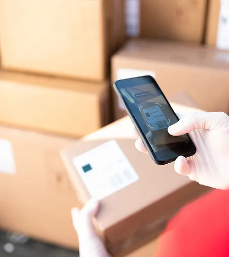 Hand scanning a parcel label with a phone