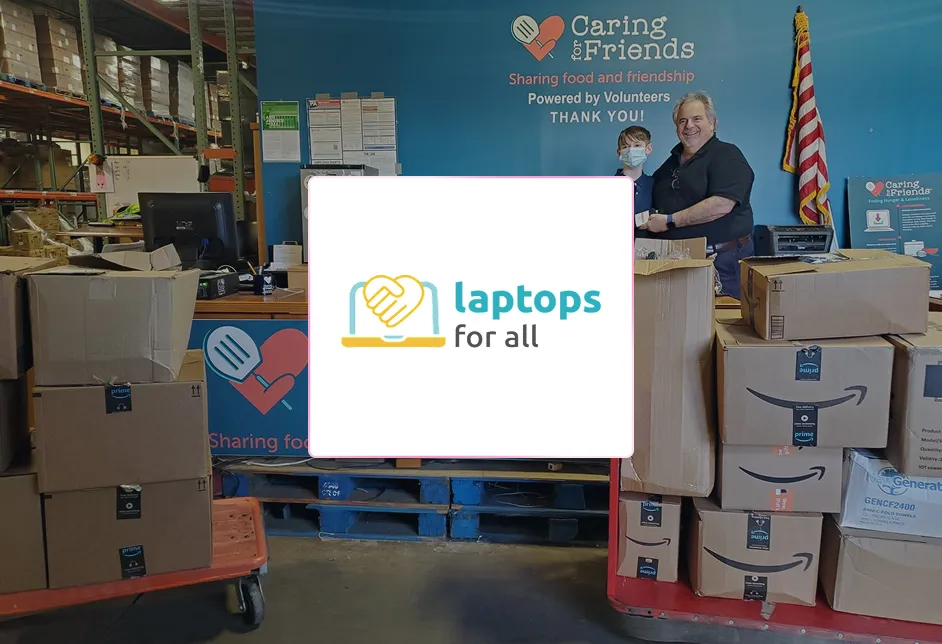 Volunteers with boxes of donated laptops at the Caring for Friends charity warehouse