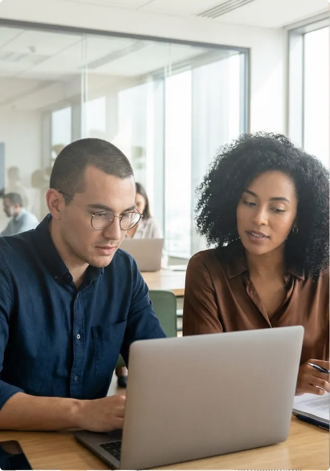 Man and woman working together on a laptop