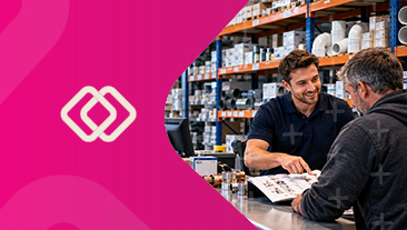 Electrical wholesaler assisting a customer at a trade counter in an electrical supplies warehouse.