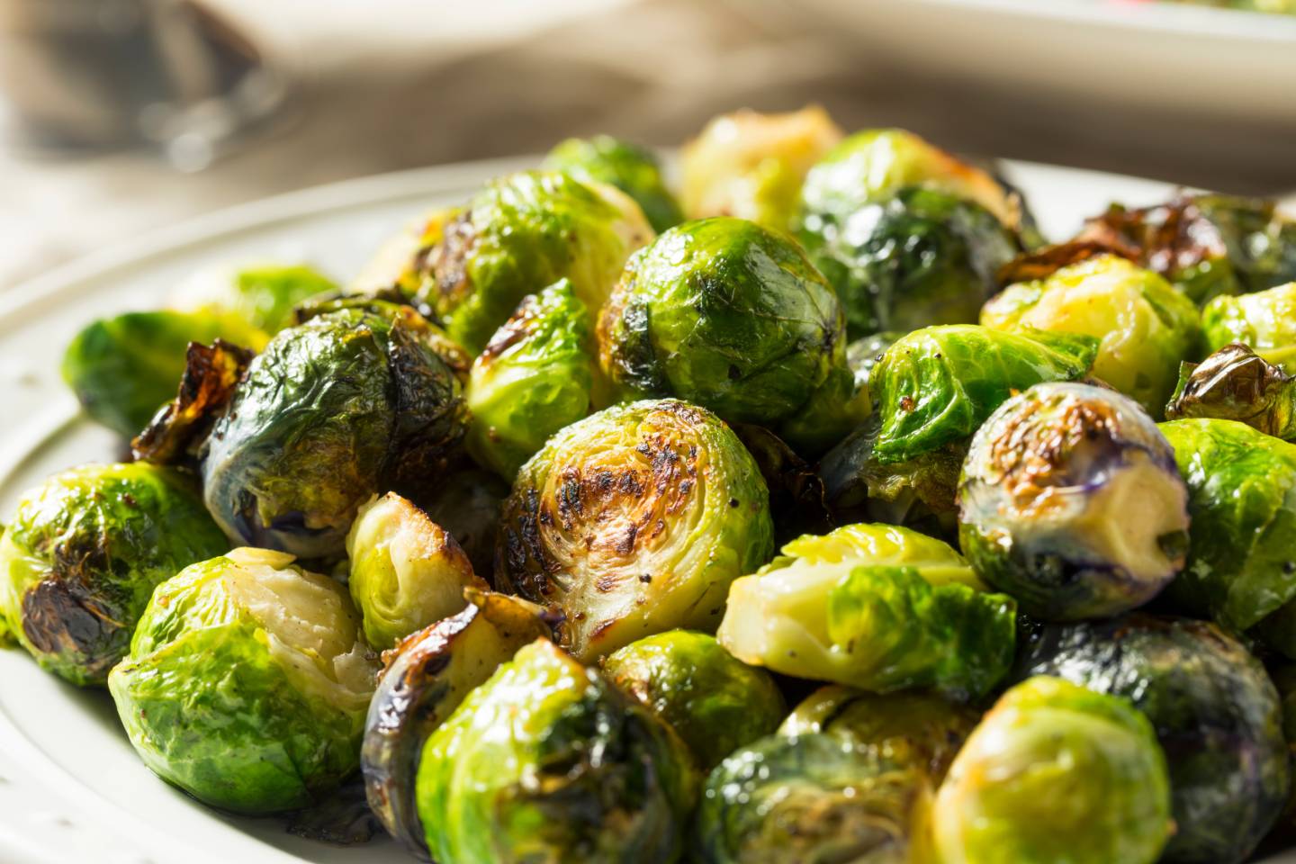 Plate of roasted Brussels sprouts with crispy browned edges.