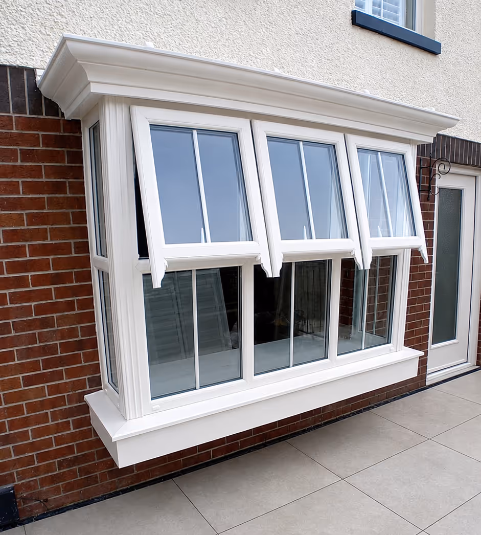 White uPVC bay window installation with opening casement windows on a brick house