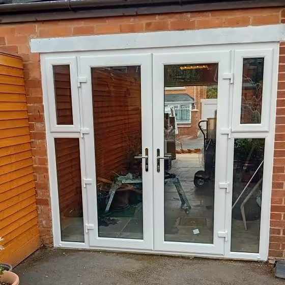 After photo of White uPVC French doors with side windows fitted after garage conversion