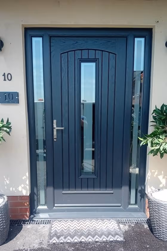 Anthracite grey composite front door with full-height glass side panels fitted in Northern Ireland