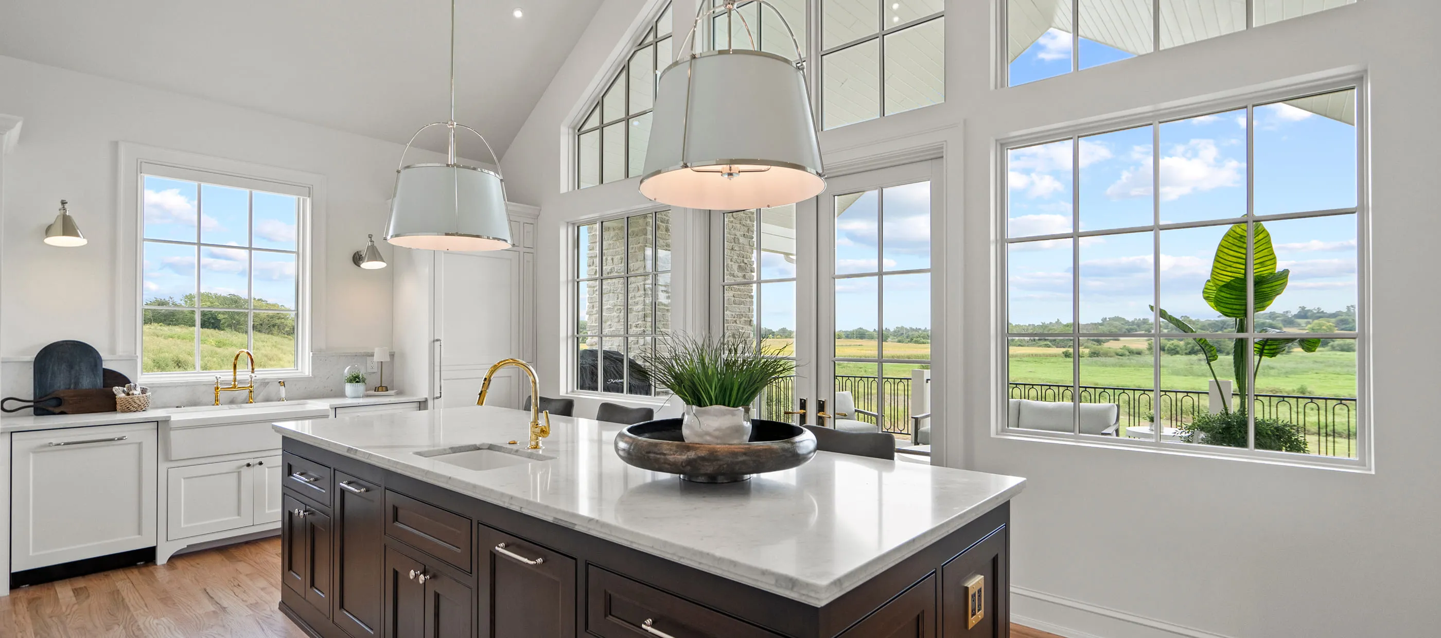 A large kitchen with a center island with a bowl on it.