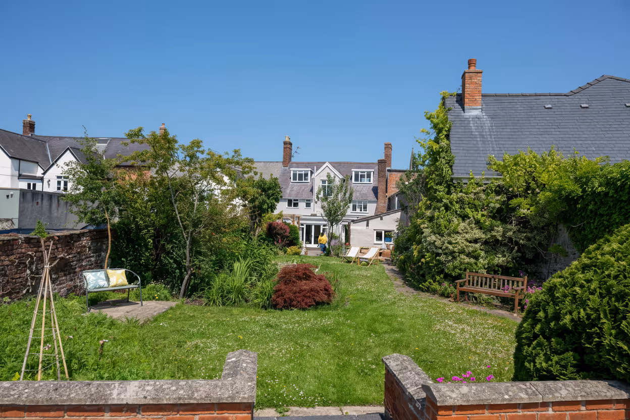 View over a walled garden toward Welsh townhouses
