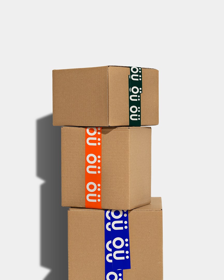 Odd Universe stacked shipping boxes with bold orange ou monogram branding