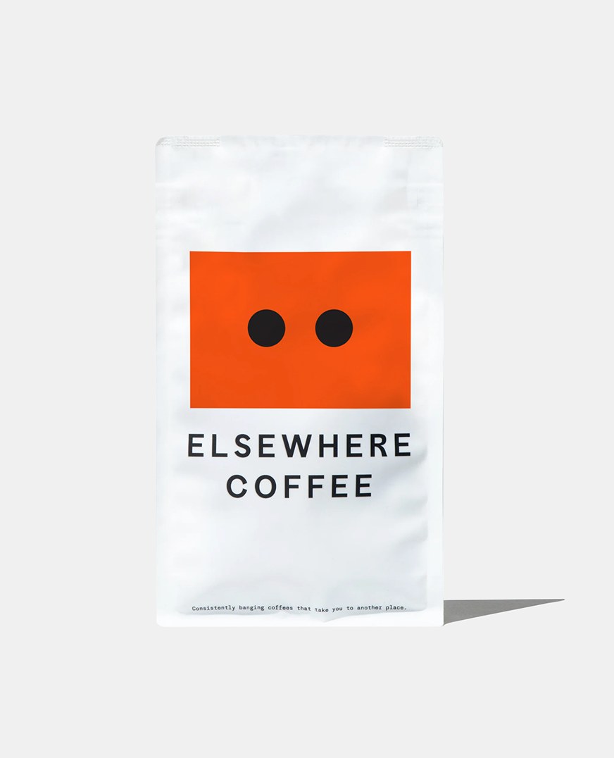 Odd Universe Ellsewhere Coffee pouch in white with orange dot graphics and bold ou branding