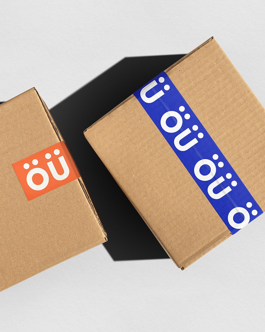 Odd Universe boxes wrapped in branded packing tape repeating the orange ou monogram