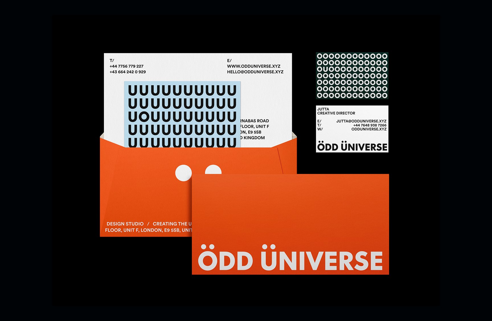 Odd Universe stationery suite in orange and cream with the ou logo on a black background