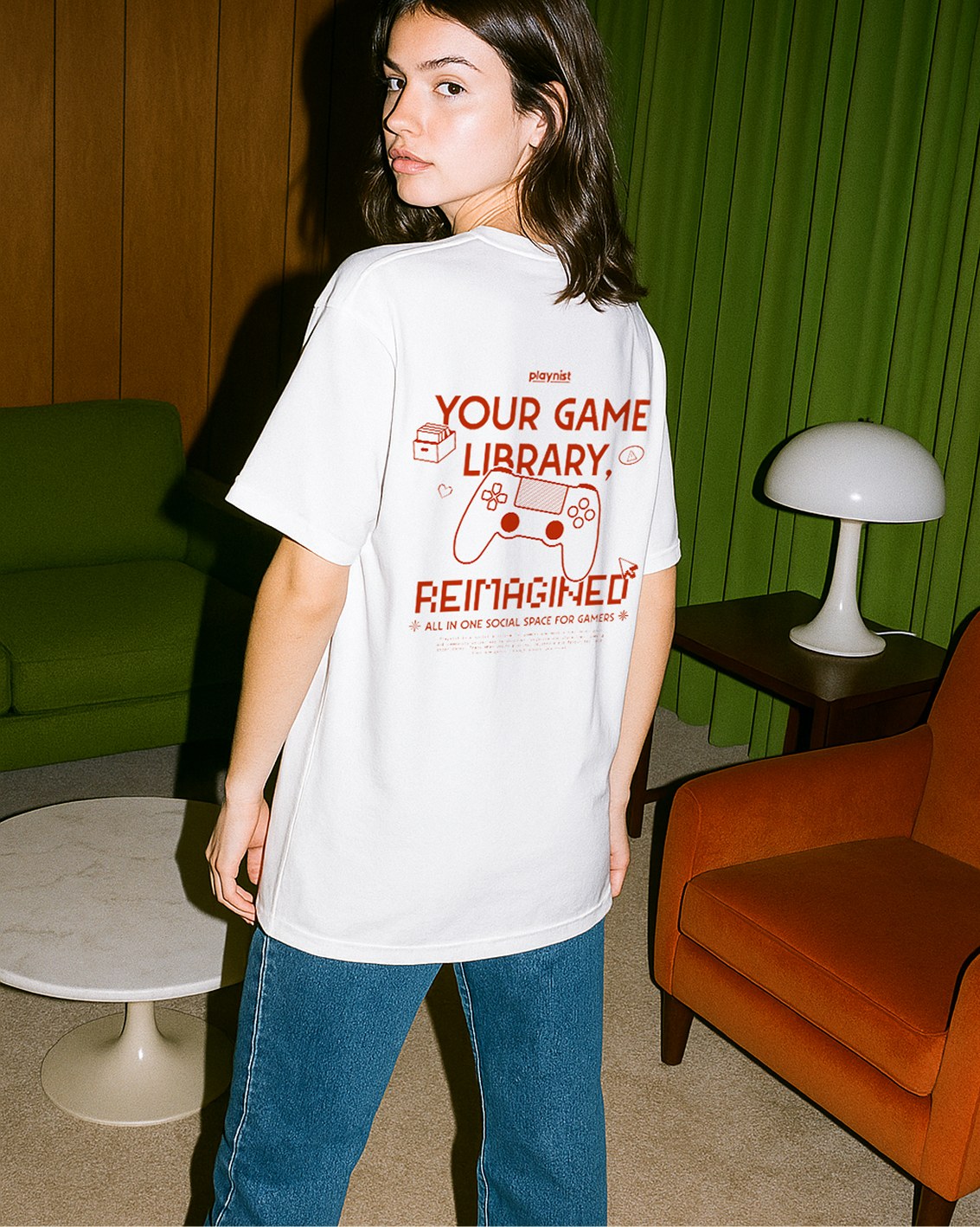 Playnist 'Your Game Library Refreshed' white t-shirt mockup against a green chair