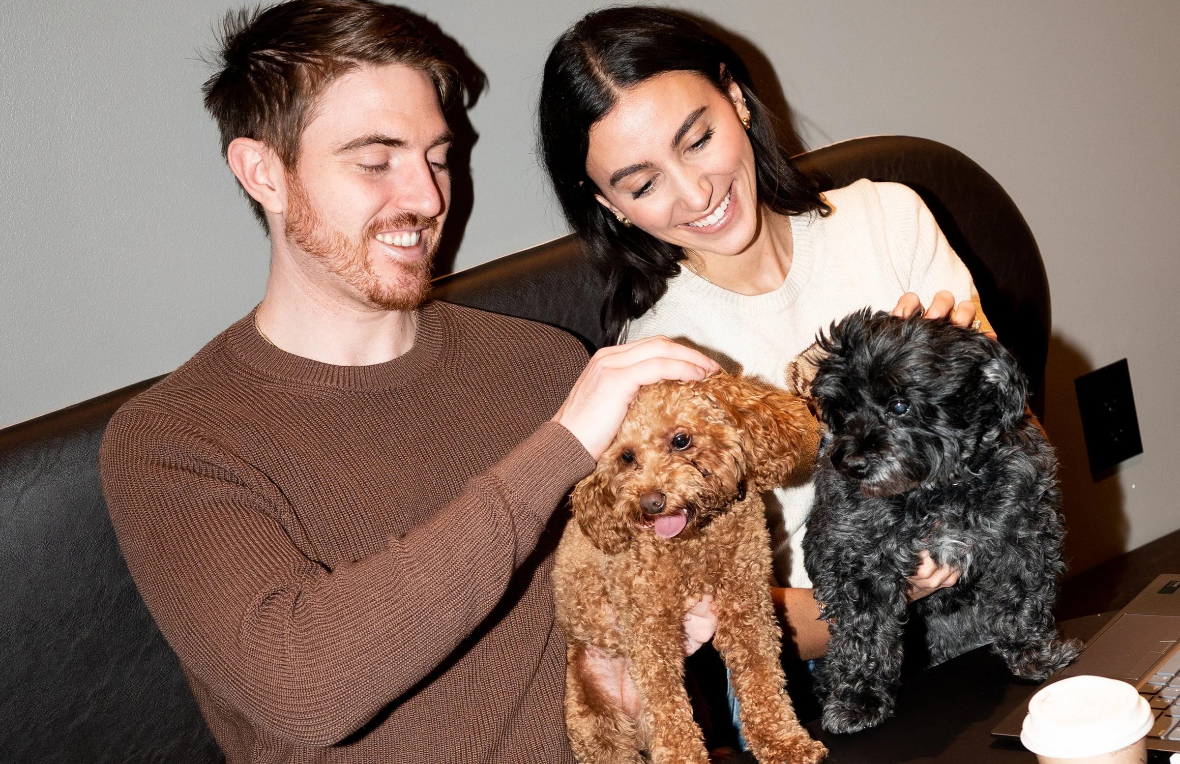 Hound House lifestyle photography — members relaxing together with their dog in warm natural light