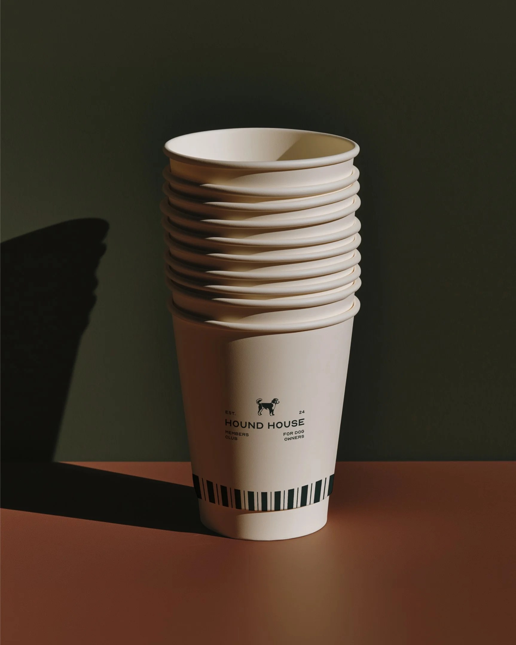 Hound House branded takeaway coffee cup in the brand palette
