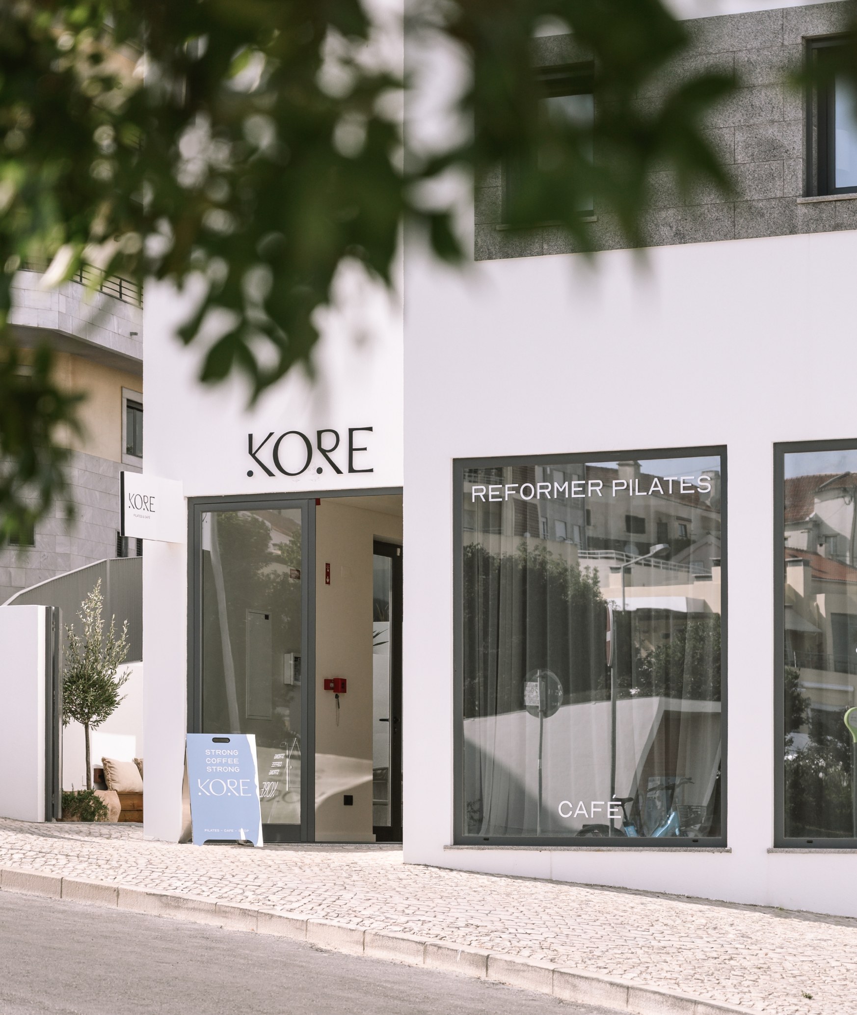 Kore Pilates studio window signage seen from the street with the logo on the glass