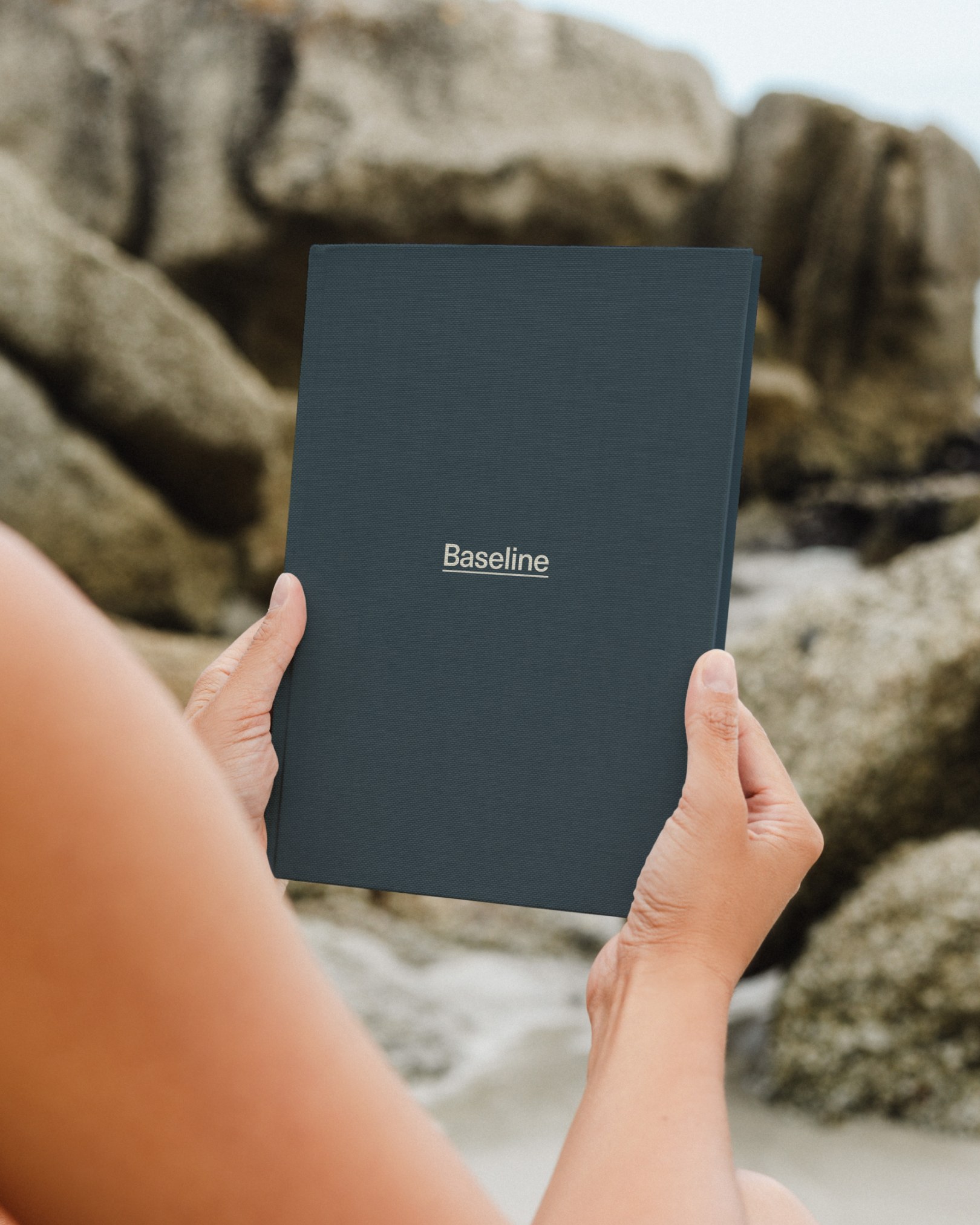 Baseline app held on a tablet against a rocky backdrop
