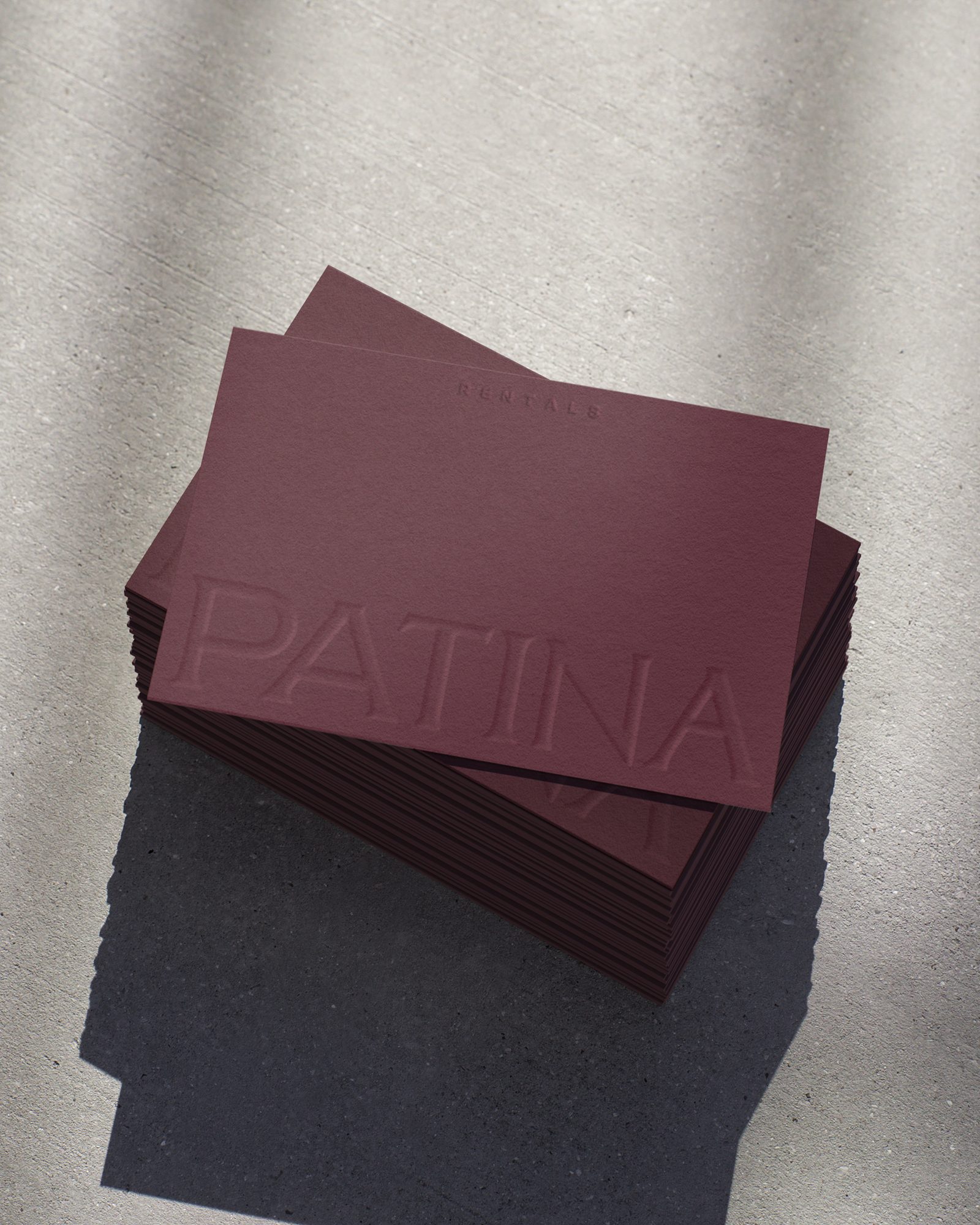 Patina plum and navy folders on textured grey
