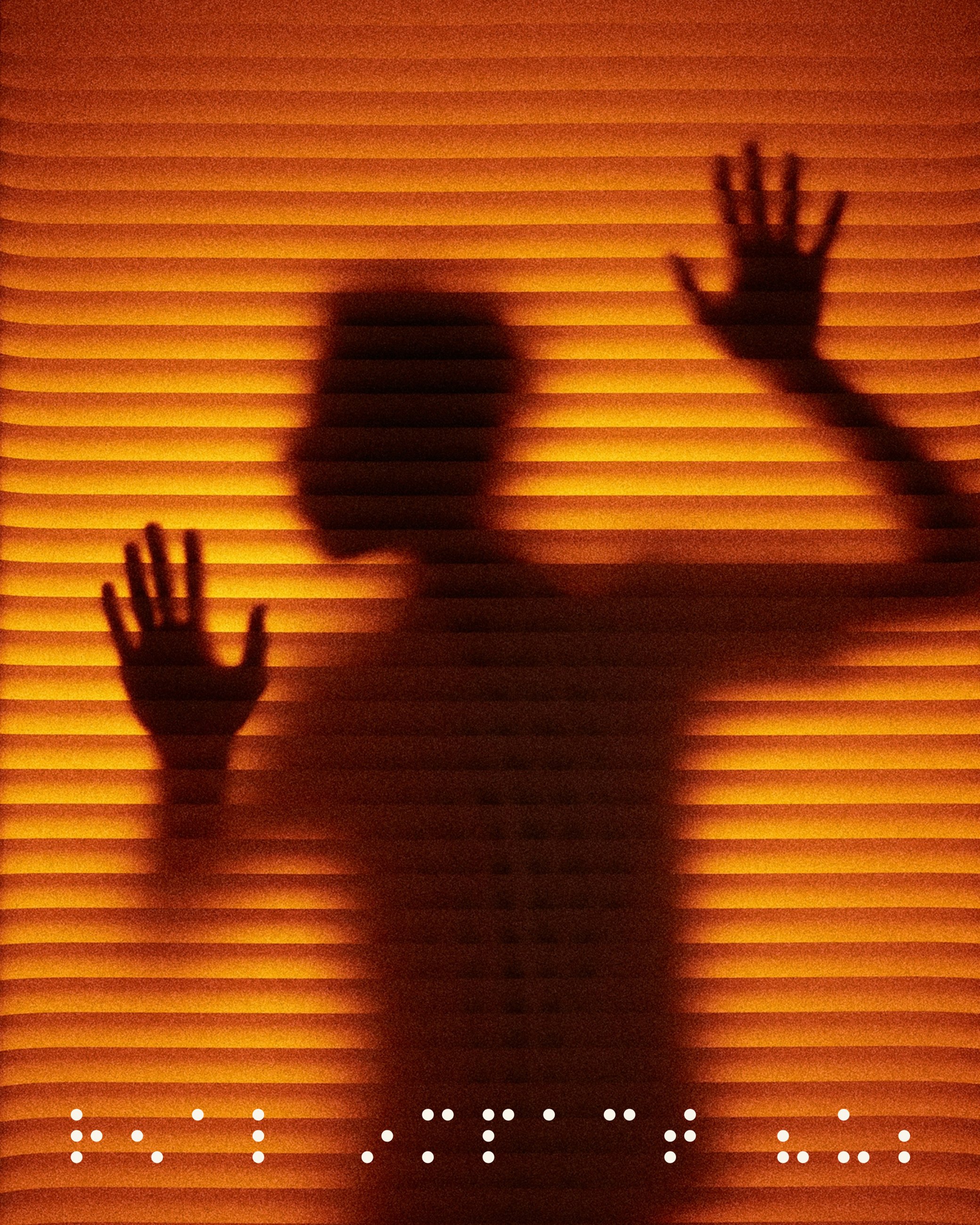 Silhouette of hands pressed against textured glass in warm orange light for Real Impact Hub