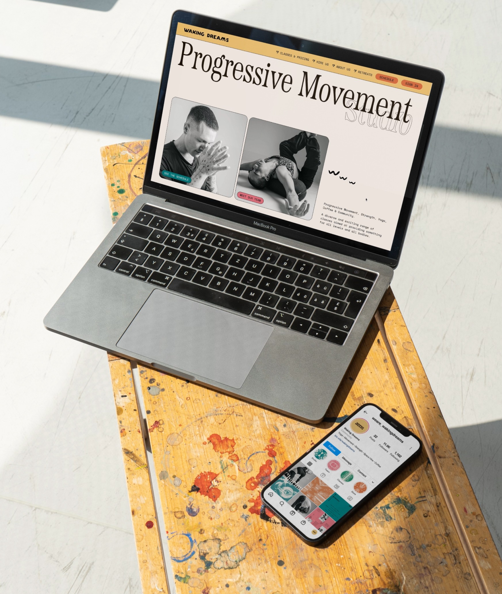 Waking Dreams Progressive Movement website homepage on a MacBook with the brand's Instagram profile on a phone beside it
