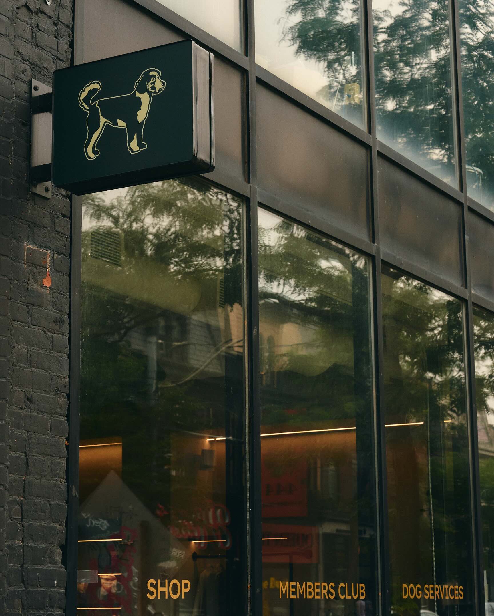 Hound House hanging dog sign outside the members club shopfront in Toronto