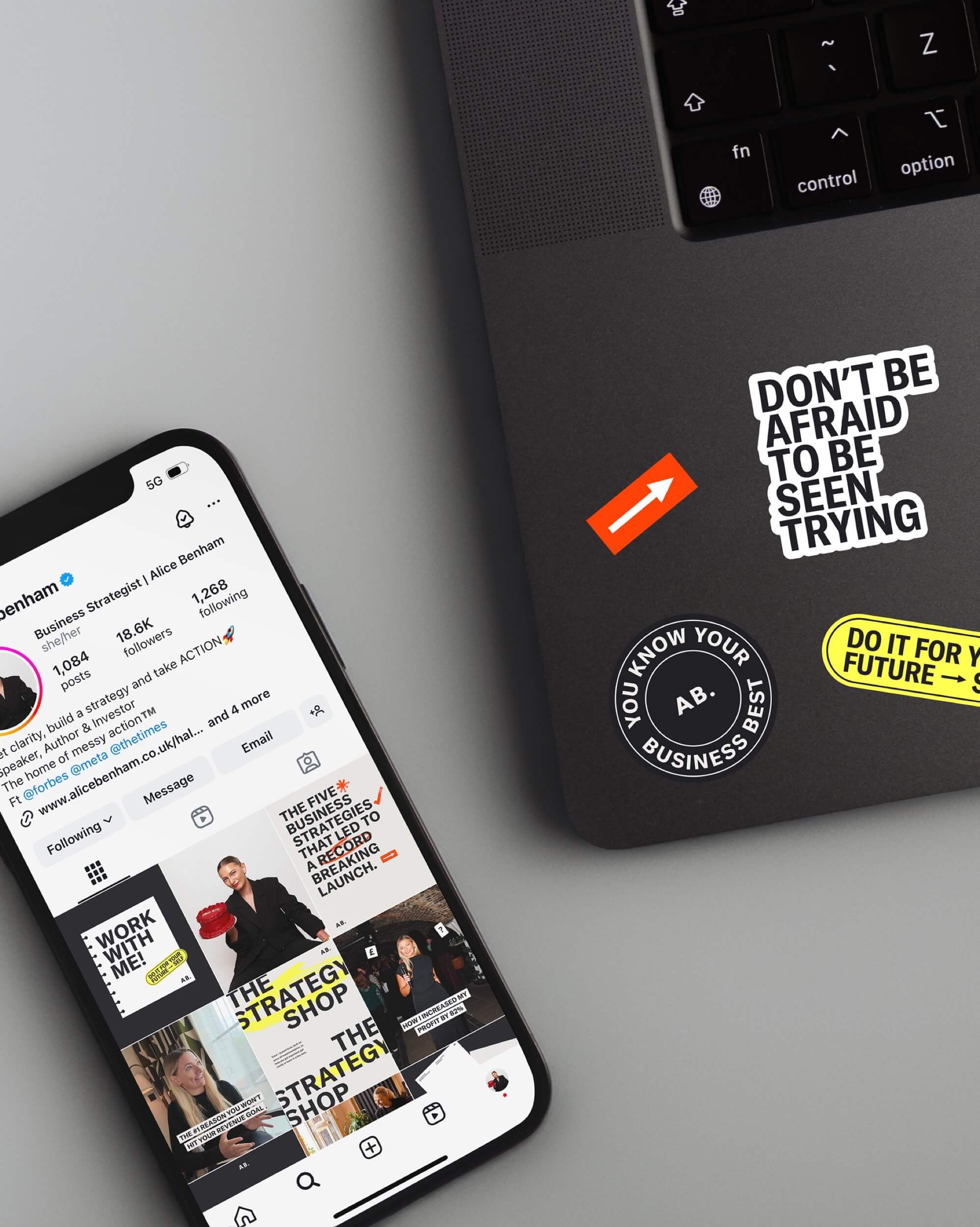 Alice Benham brand stickers on a laptop beside a phone showing her refreshed Instagram grid