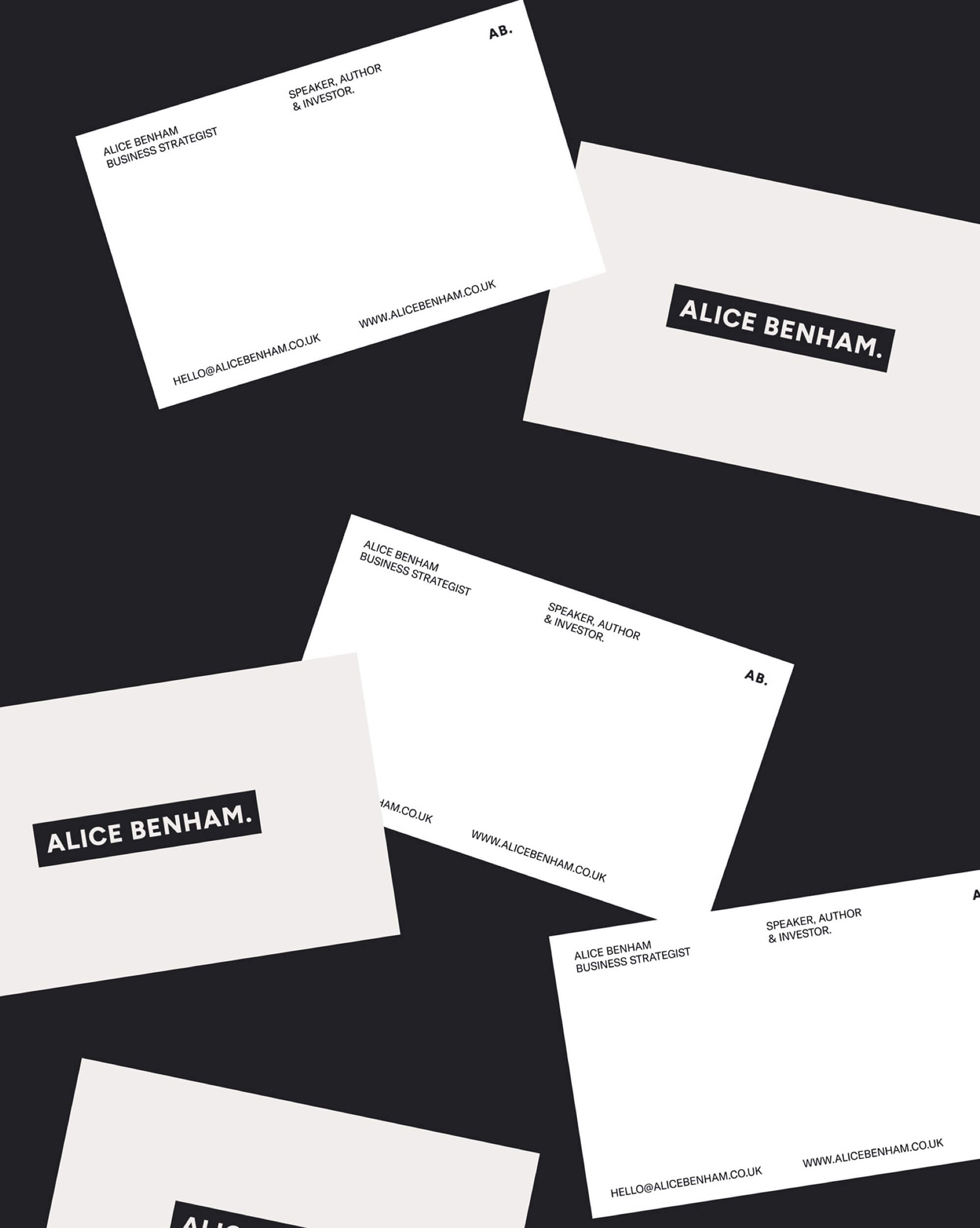 Alice Benham business cards scattered on charcoal, showing the wordmark front and contact details back