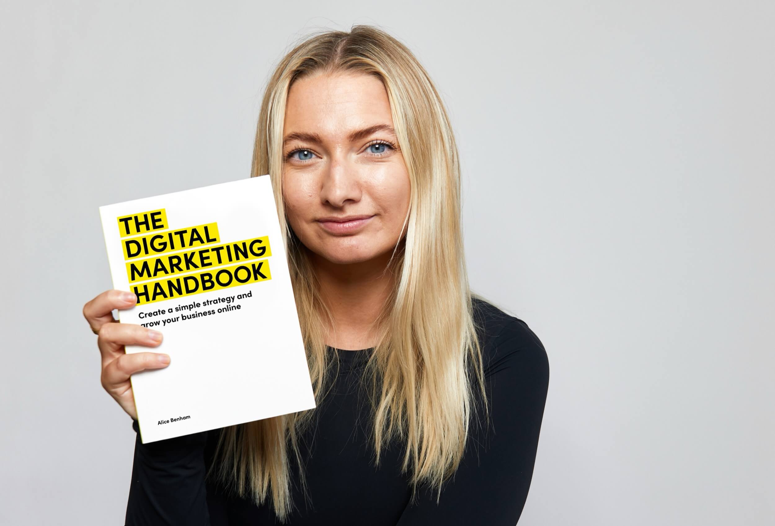 Alice Benham holding The Digital Marketing Handbook, a lead magnet designed in her new brand identity