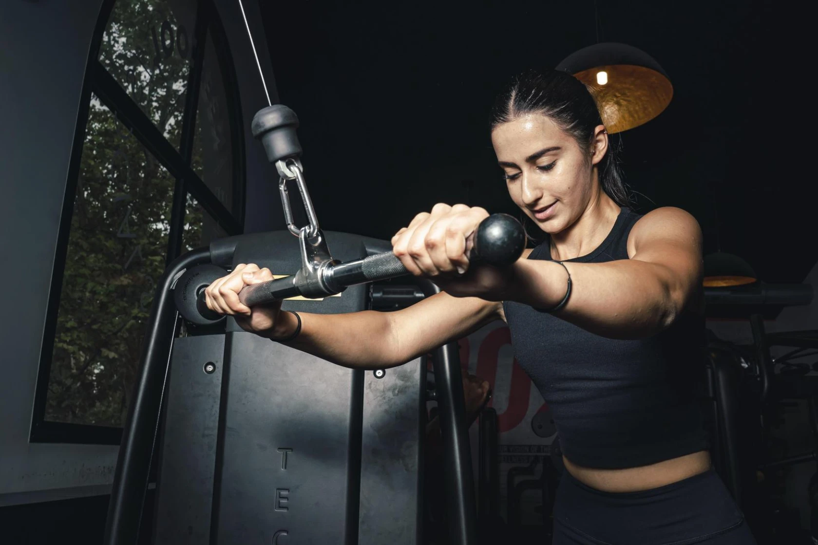 Femme utilisant machine à biceps en salle de sport Keepcool