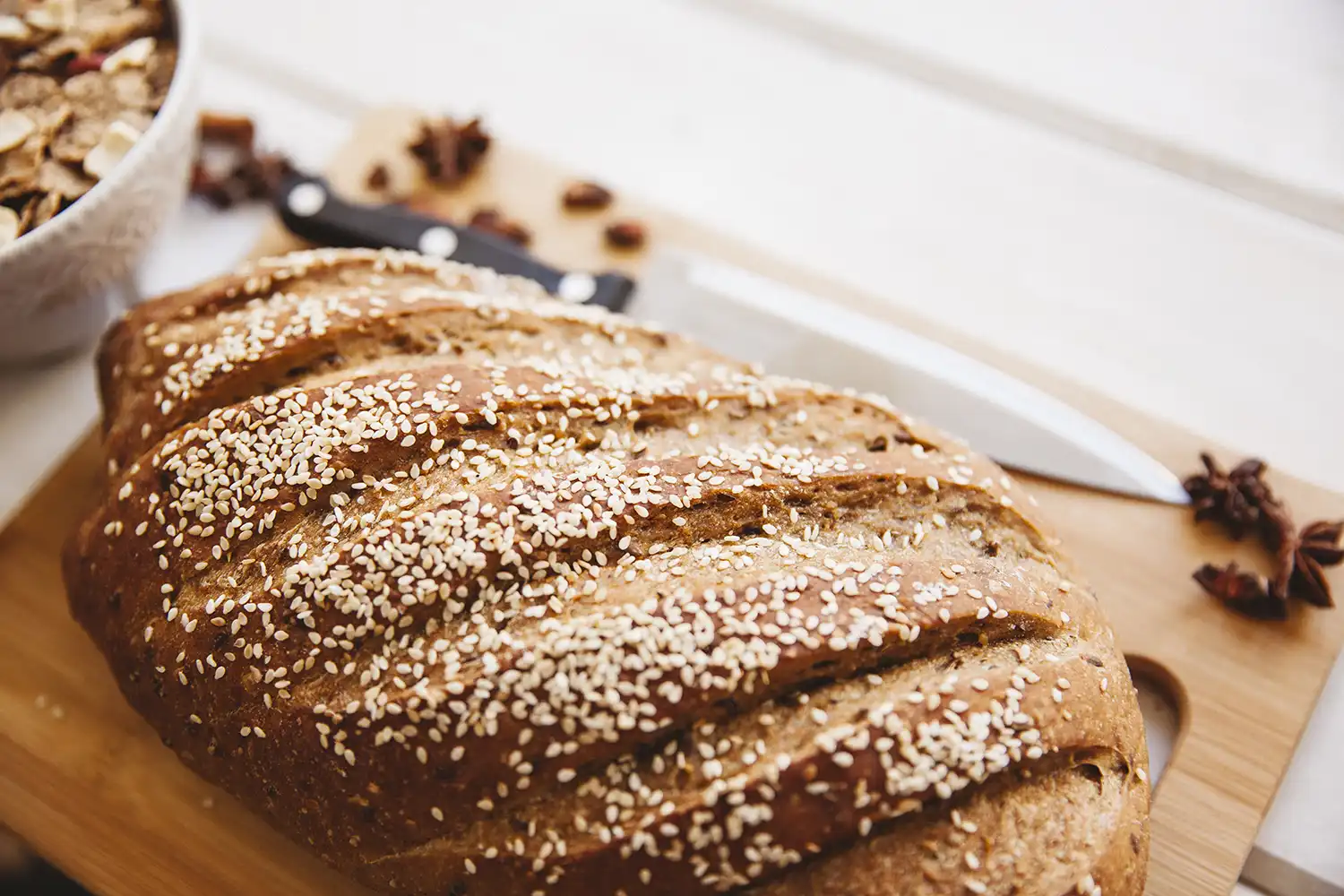 Pain sans gluten aux graines sur planche bois, idéal pour alimentation équilibrée et énergie sportive