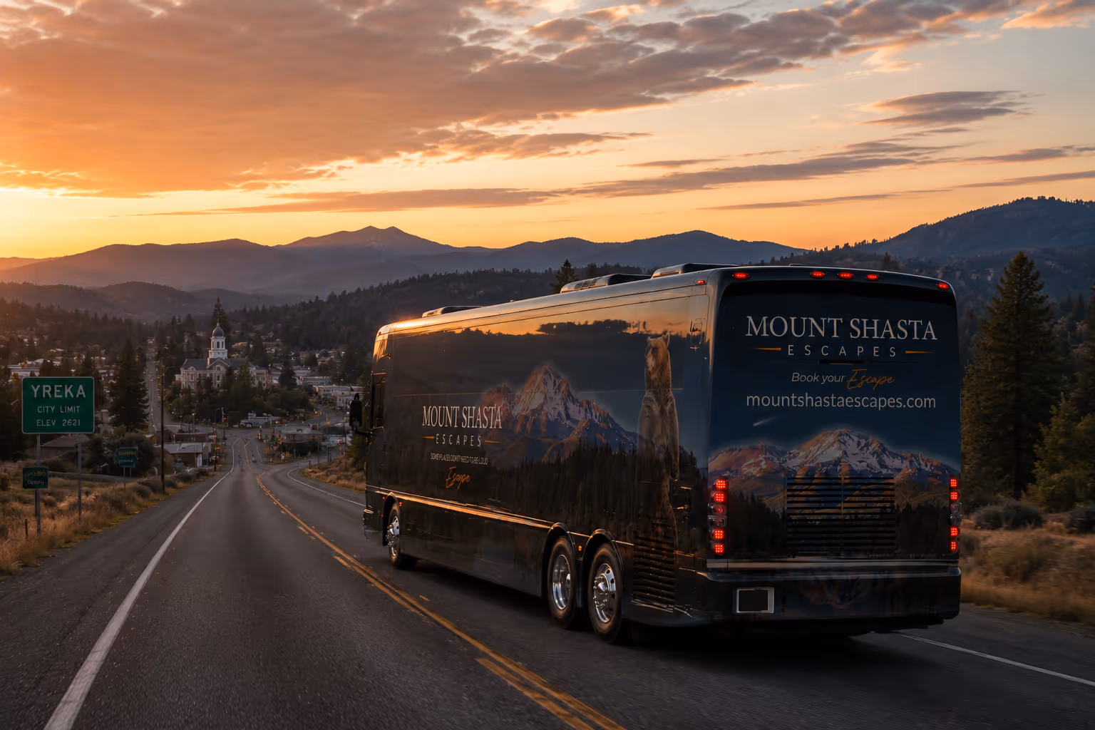 A truck driving down a road with mountains in the background.