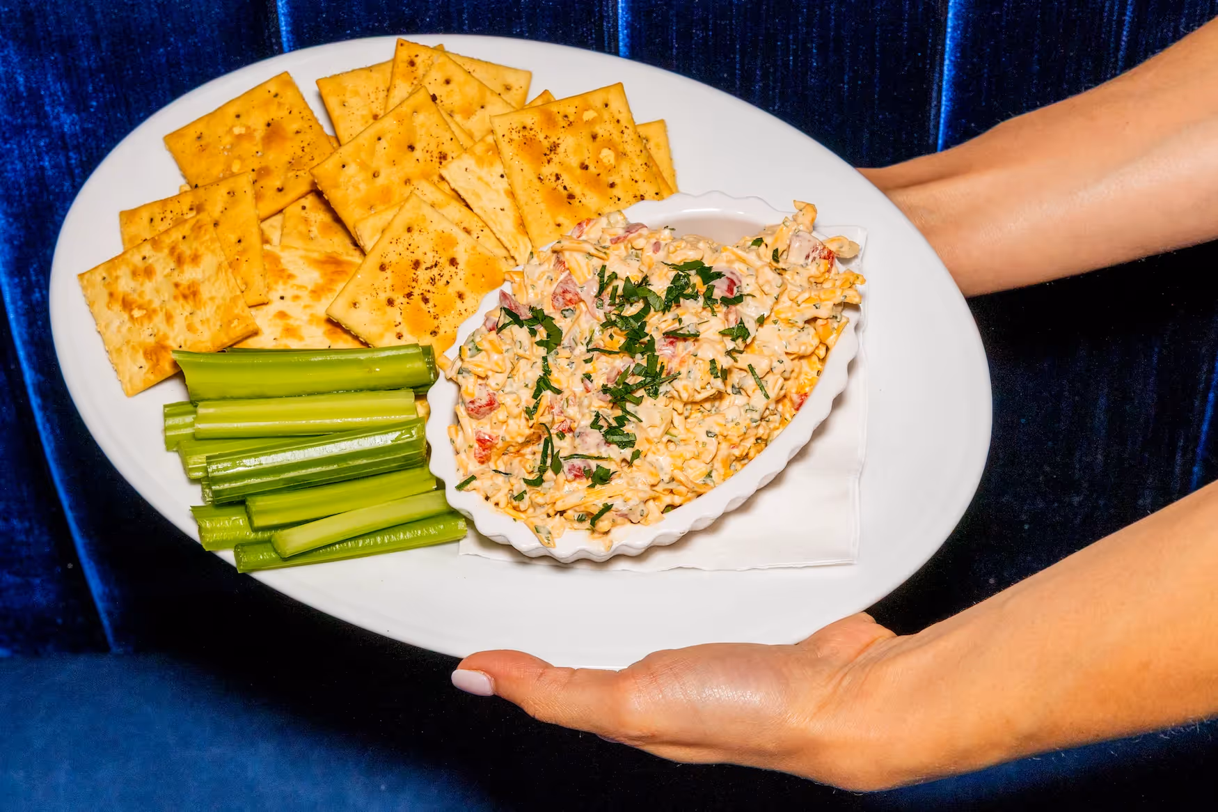 A plate of food with a white plate and a blue background.
