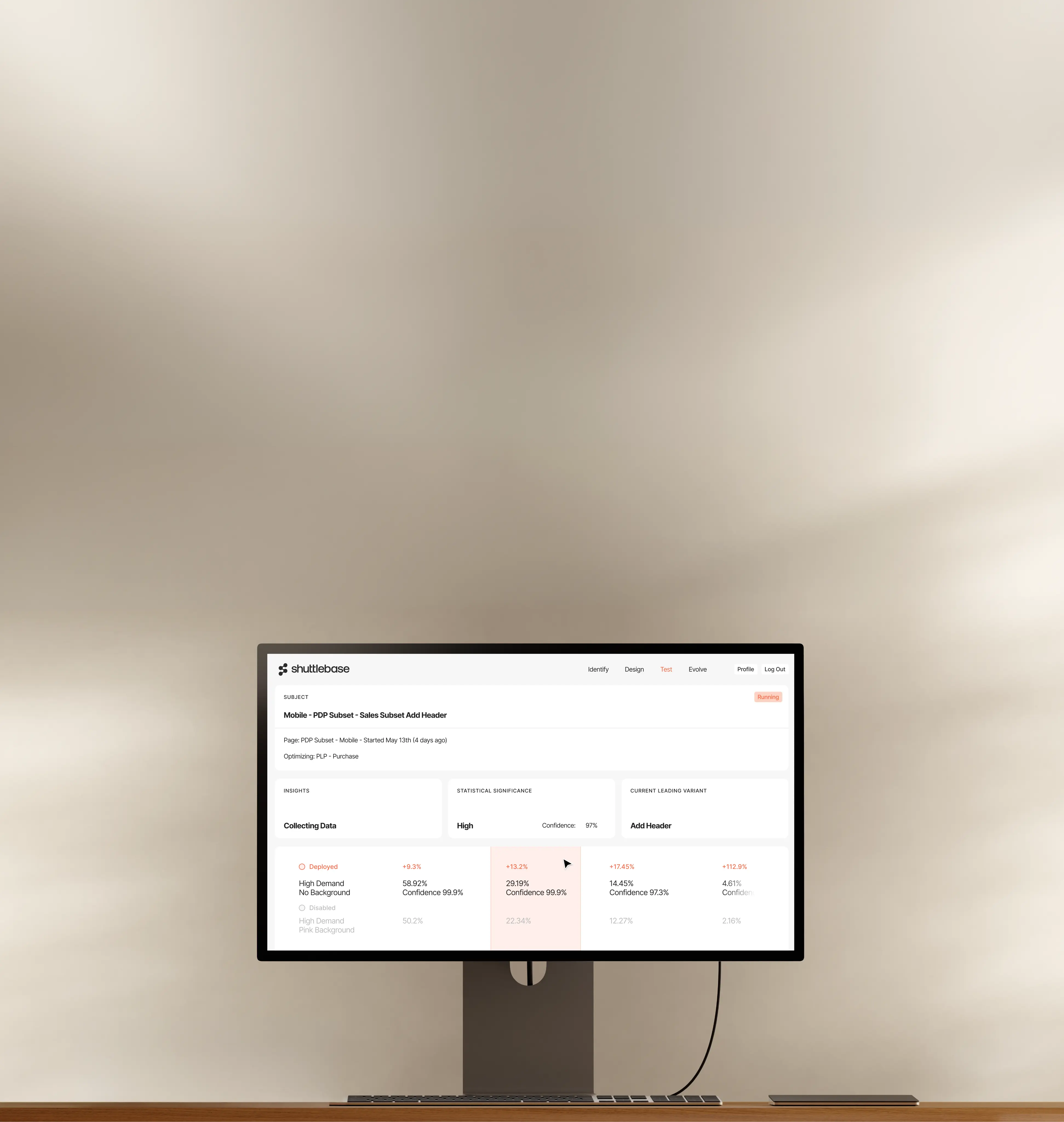 Computer monitor on desk displaying Shuttlebase dashboard with test data and statistics.