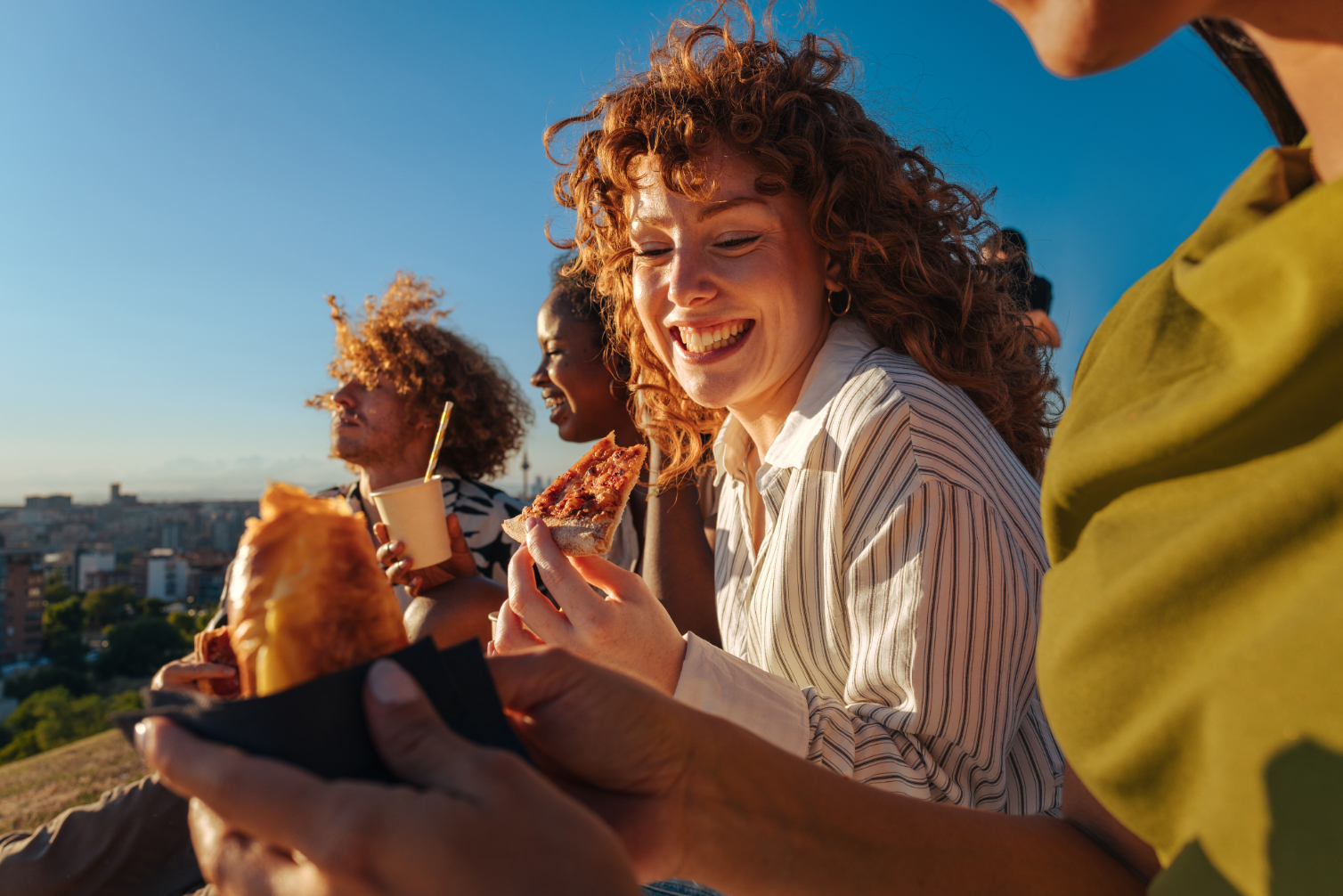 Friends on rooftop with food stock image
