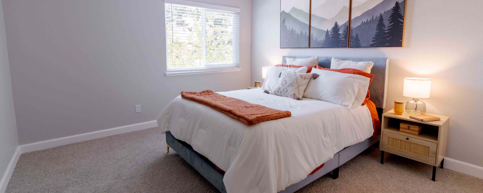 Bedroom with bed, bedside table, and large window