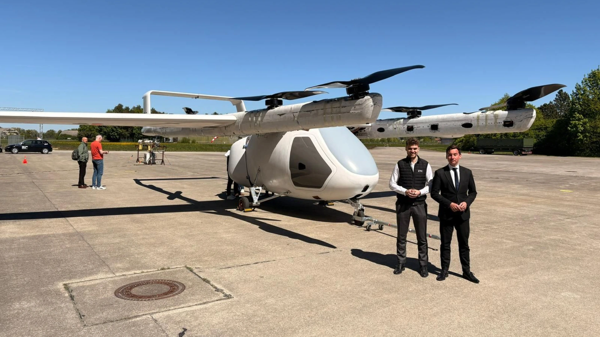 2 people standing in front of the ERC Charlie C700 aircraft.