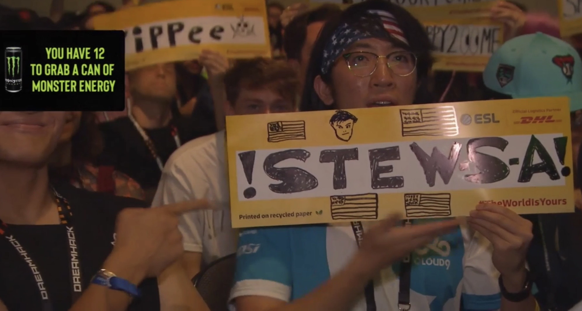 A Counter-Strike esports fan with glasses holds up a custom paper sign as he appears live on stream during the grand final match of the IEM Dallas 2024 CS2 tournament in Dallas