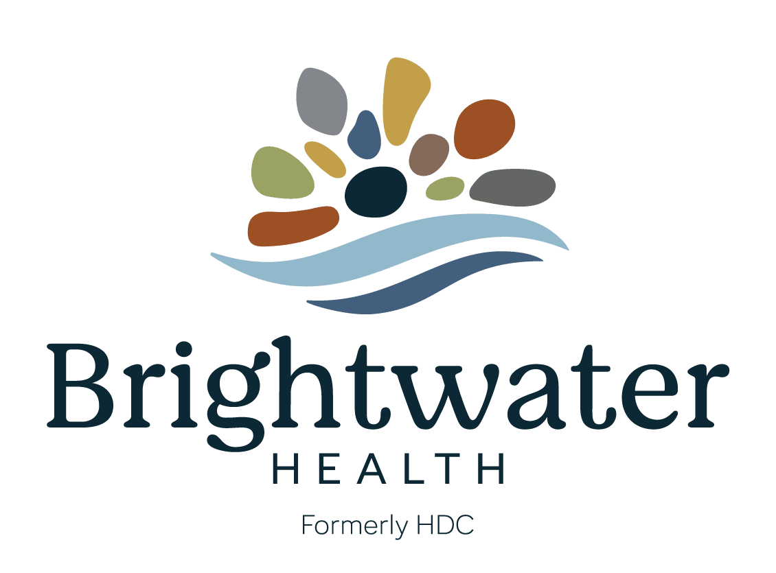 Brightwater Health logo with multicolored shapes above stylized blue waves and text reading Formerly HDC.