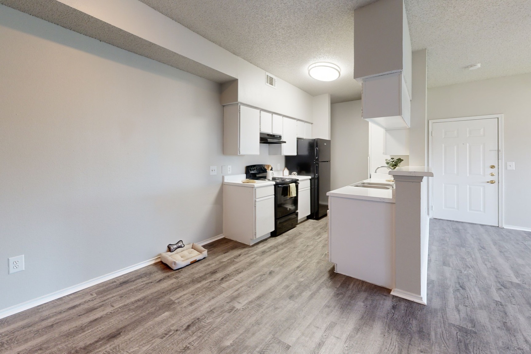 Kichen with Black Appliances at The Ranch at Frisco Apartments in Frisco, TX