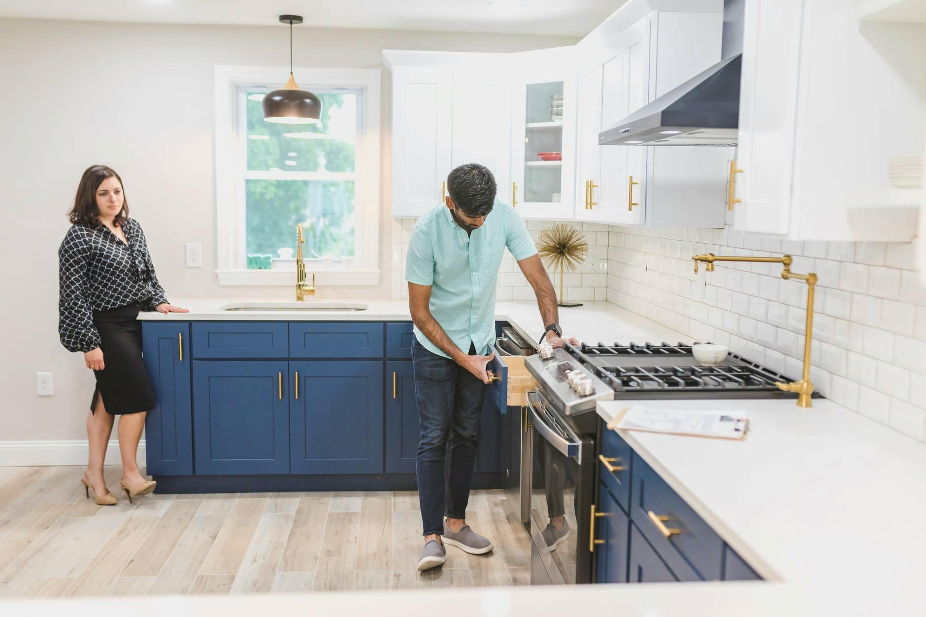 a man inspecting the kitchen drawer