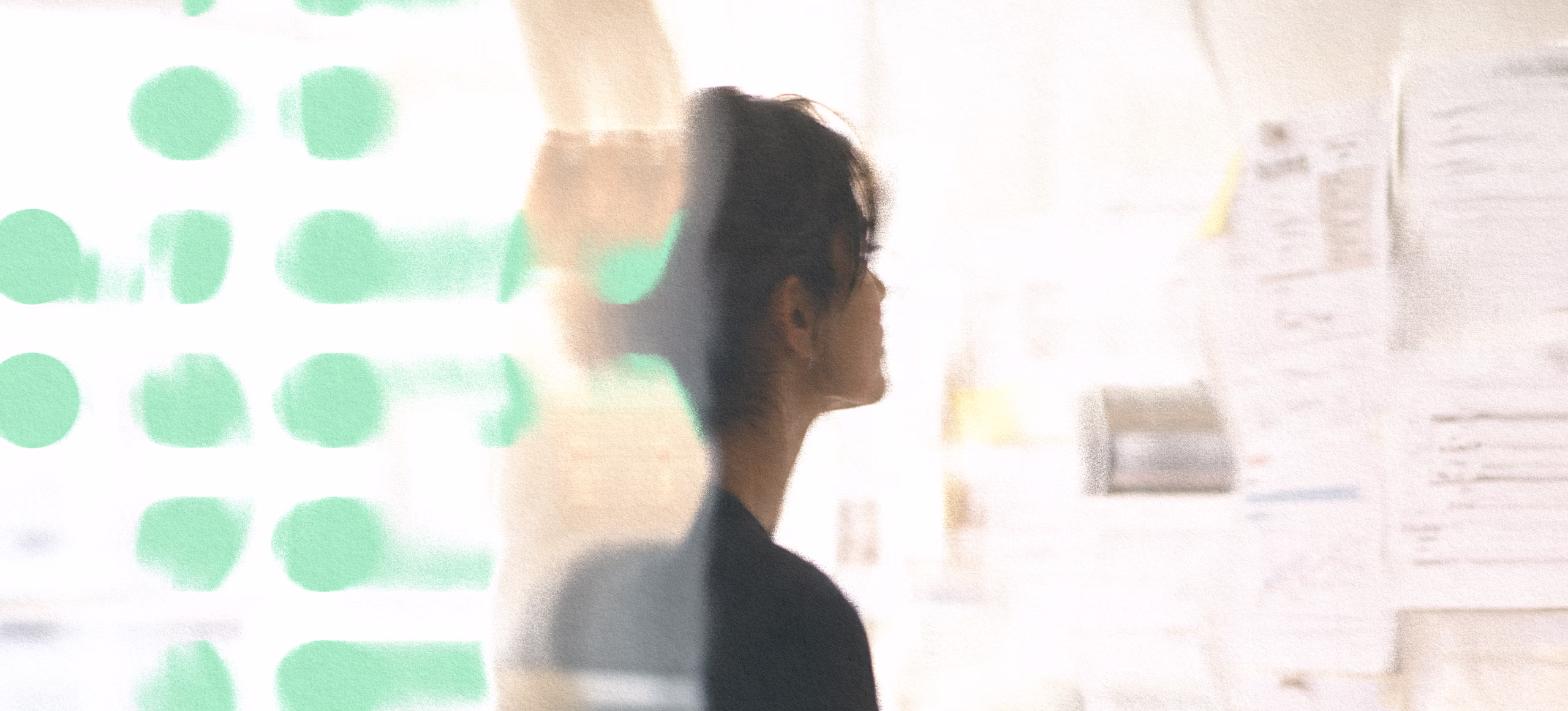 Abstract branded banner with green dot pattern layered over a person's silhouette in a strategy environment