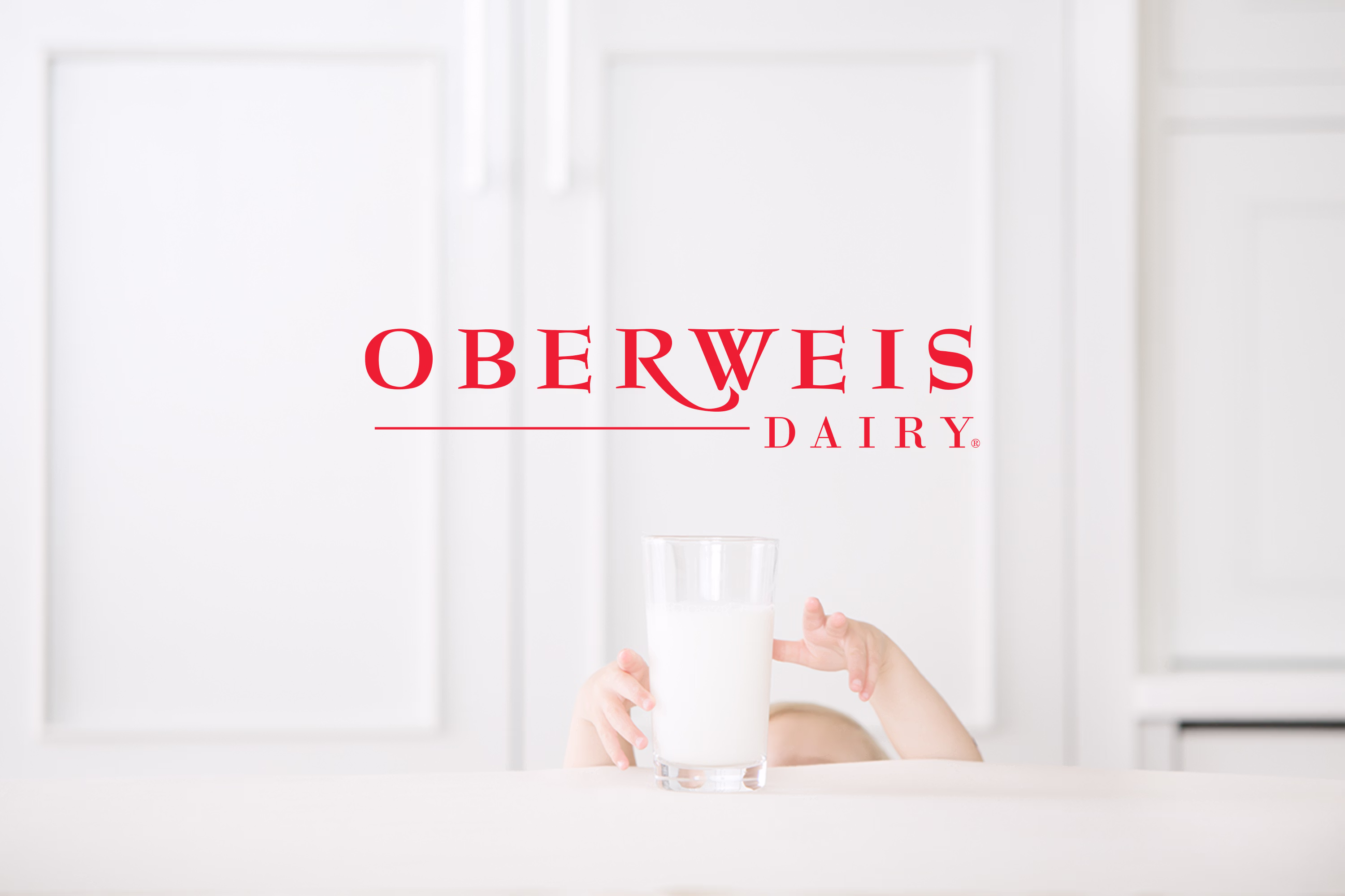 Oberweis Dairy logo alongside a glass of fresh milk on a clean white background