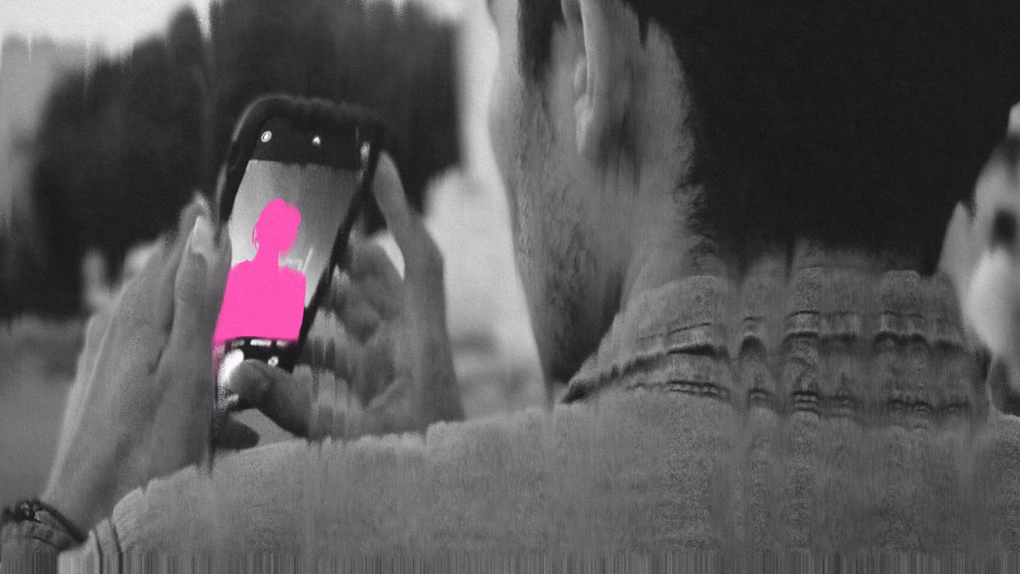 Man filming video on his smart phone.