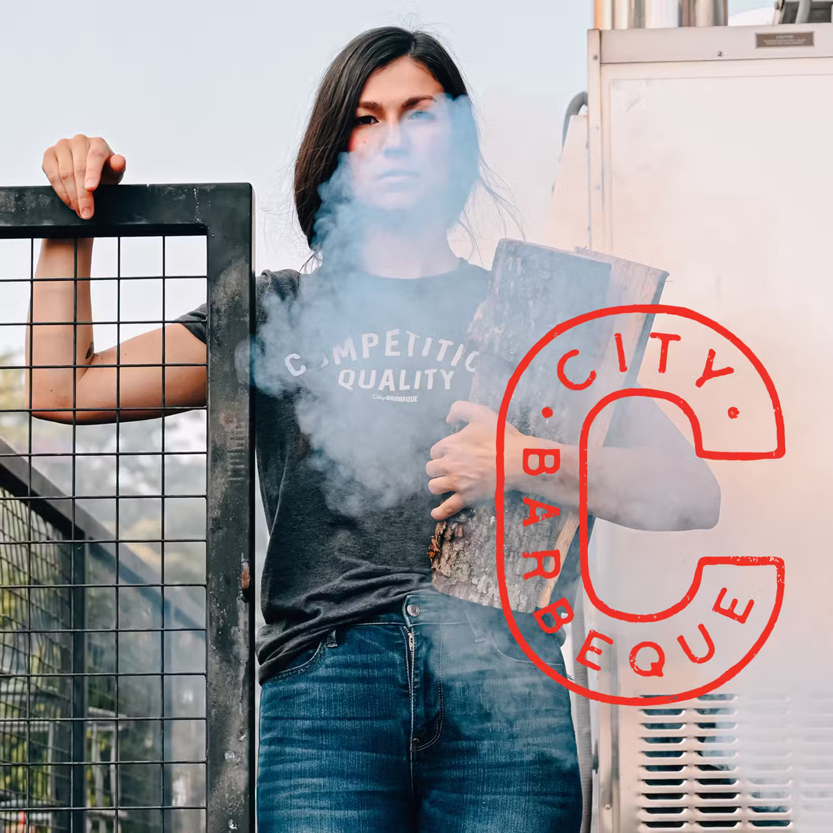Employee holding fire wood with City BBQ logo overlaid
