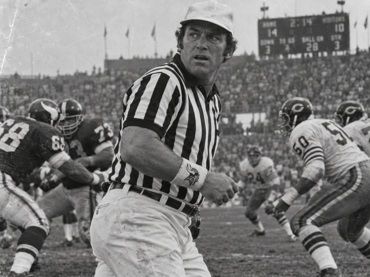 A referee glances toward the sideline mid-play.