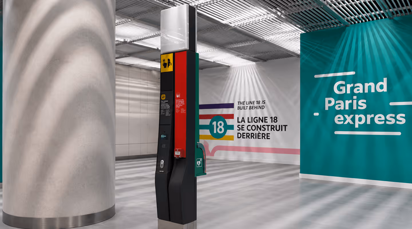 Future Paris metro station under construction with Grand Paris Express and Line 18 signage on walls.