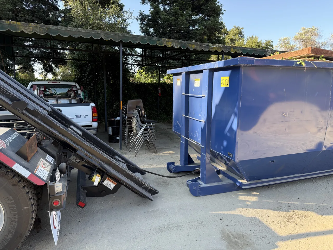 Blue roll-off dumpster set on a home driveway in the South Bay