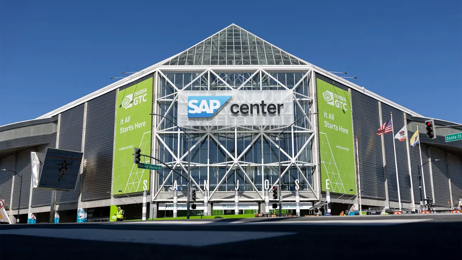 SAP Center arena in San Jose wrapped in green NVIDIA GTC banners under a clear blue sky