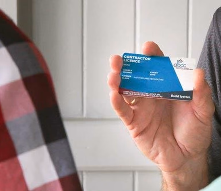 Tradesperson holding a QBCC contractor licence card