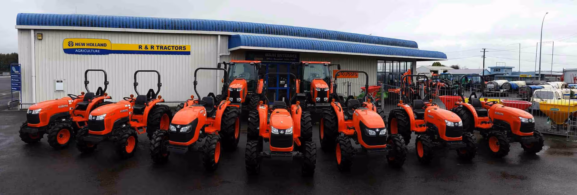 Row of Kubota tractors lined up outside the R&R Tractors dealership