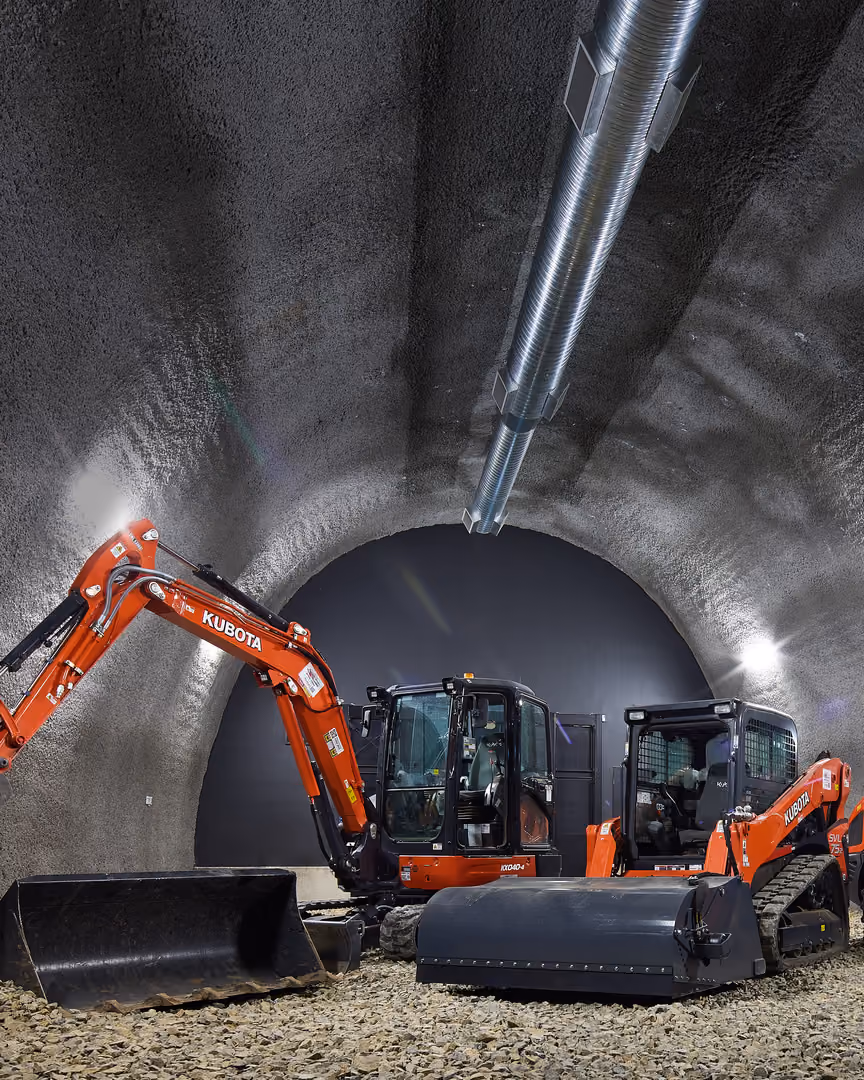 Kubota excavators and track loaders lined up inside a tunnel